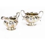 A William IV silver sugar basin and milk jug by C.G, the twin handled footed bowl with later