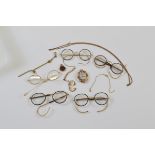 A quantity of gilt metal spectacles, some with tortoiseshell rims together with gilt metal chain,