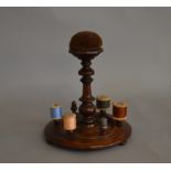 A 19th Century Mahogany Cotton Reel Stand, with central turned pedestal, surmounting in a pin