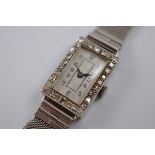 An Art Deco 18ct gold and diamond dress watch, of rectangular form with guilloche enamel face,