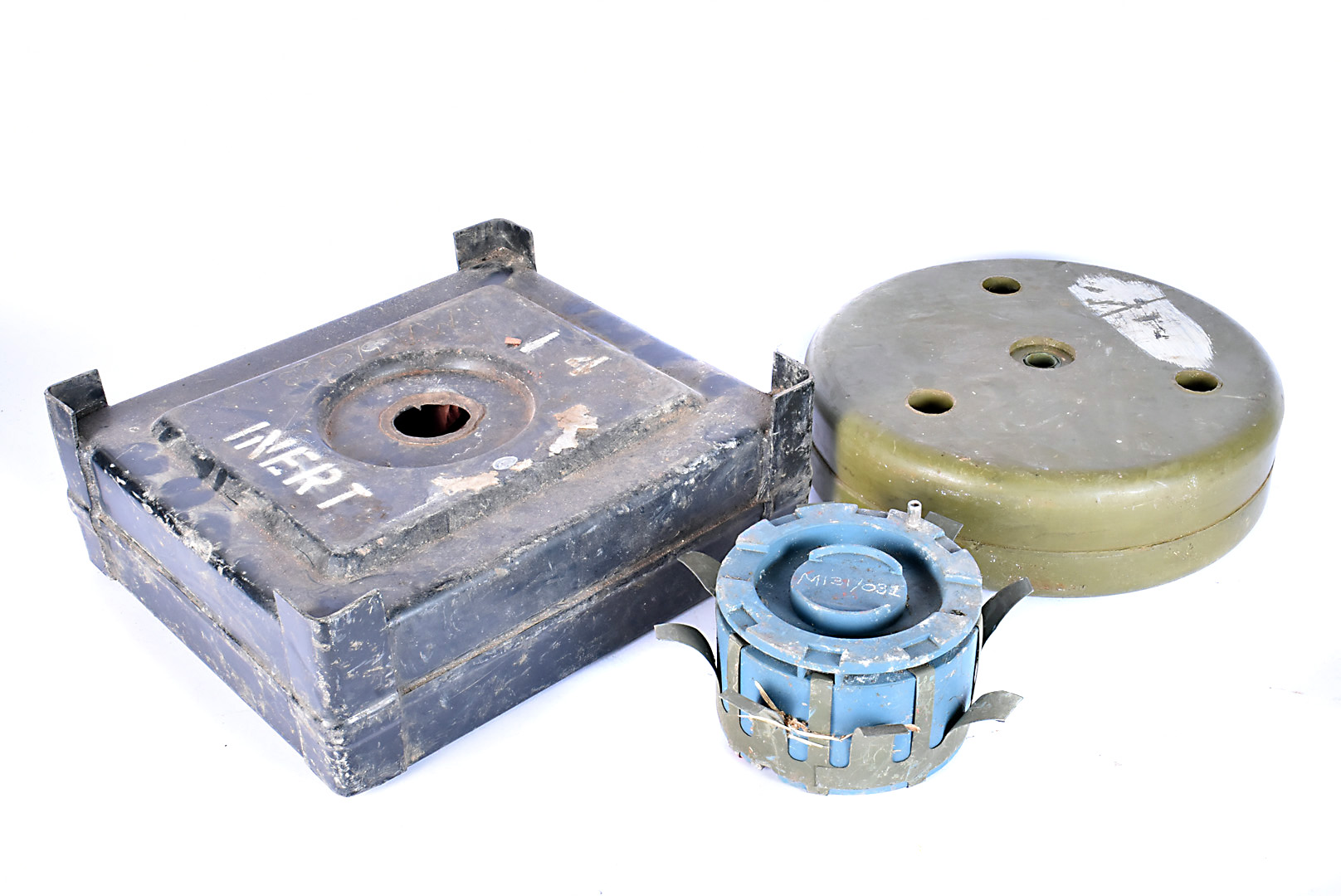 A group of three inert land mines, to include a TMA-5/003 anti-tank mine, a TMA anti-tank mine and a