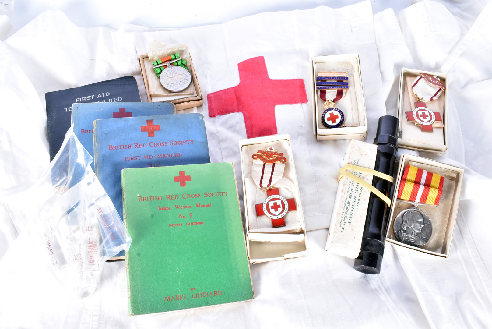 A collection of WWII period Red Cross items from Mrs Norma May Sumner, including Defence Medal,