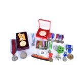 An assortment of British and Overseas Medals, to include a 1935 Coronation medal, a WWII miniature