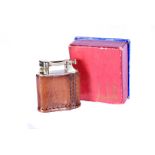 A 1940s Standard Model Dunhill lighter, petrol, patent 390107, with brown leather jacket, complete