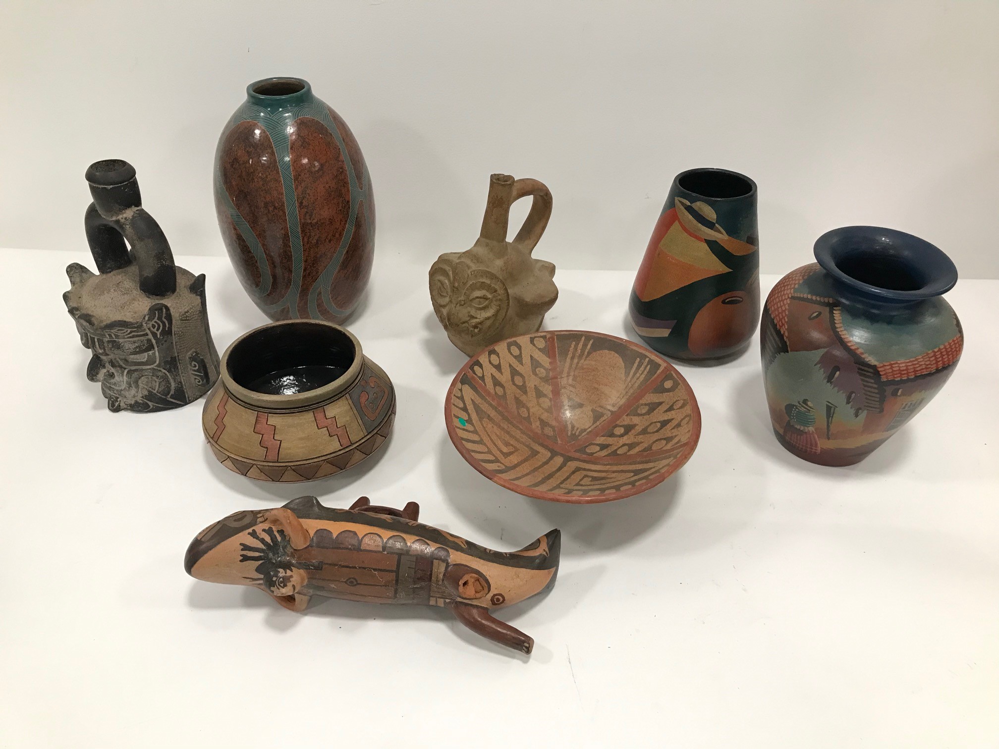 A group of eight reproduction pre-Columbian style and South American pottery items, varying styles