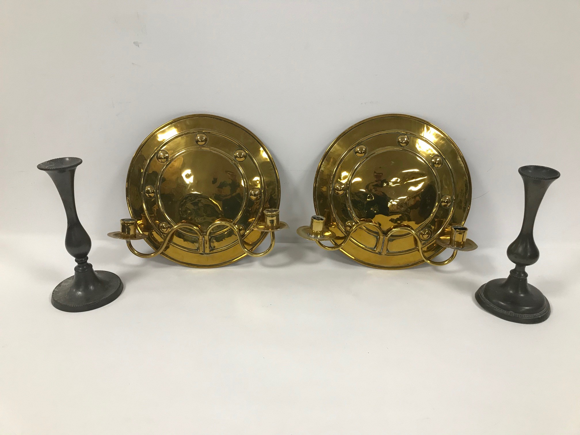 A pair of mid 20th century brass circular wall sconces, 29cm diameter, together with a pair of