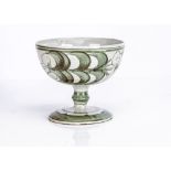 An Aldermaston Pottery footed bowl, with green decoration, signed VC to base, 19.5cm diameter and
