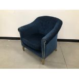 A modern tub style armchair, with blue upholstery