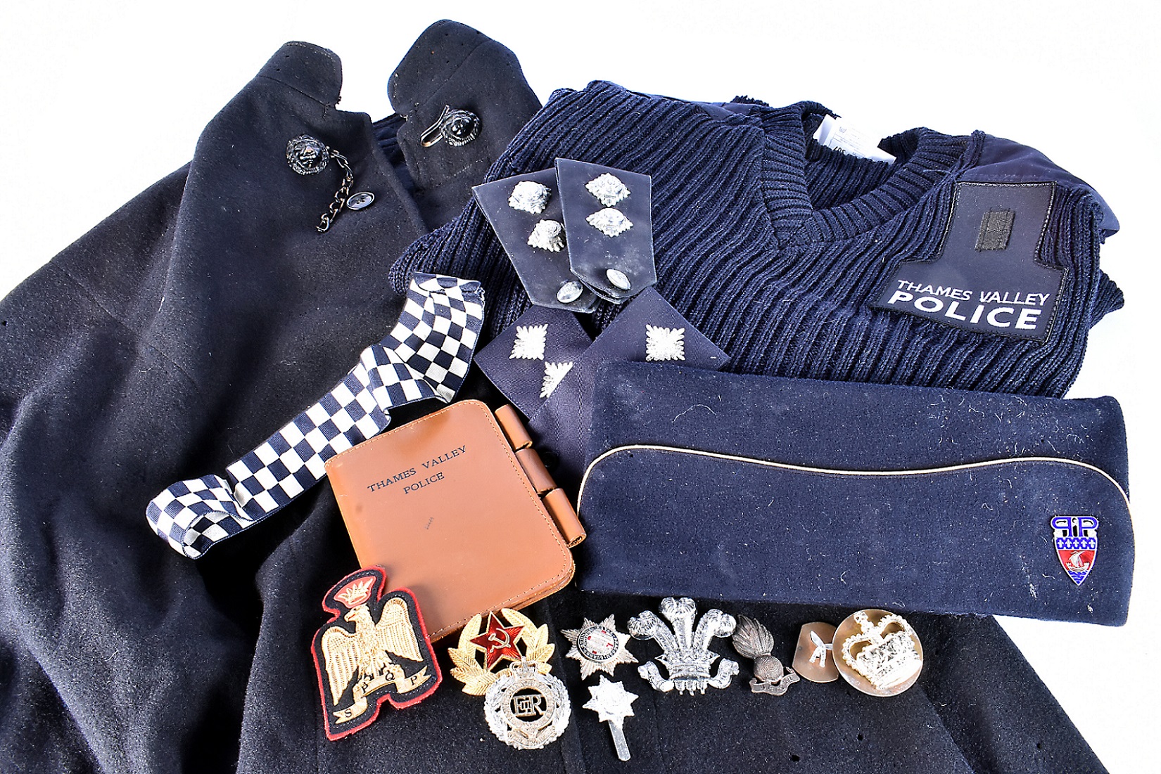 An assortment of Police Uniform items and badges, including a J Compton, Sons & Webb Ltd cape,