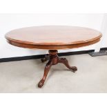 A 19th Century and later mahogany oval tilt top table, with carved tripod base, 127cm x 105cm x