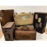 Five items of vintage luggage, including a doctor's style holdall, a white calf hide suitcase, a