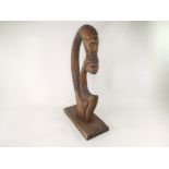 A 20th Century tribal or folk art figural carving of mother and child, a watercolour on paper of a