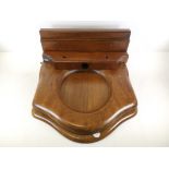An early 20th Century oak toilet seat, 46cm x 42cm