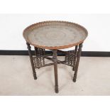 Middle eastern copper tray table, on folding pentagonal frame.