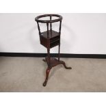 19th Century mahogany wash stand, Circular rim mounted on turned supports above two tiered shelf,