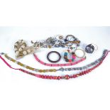 A quantity of costume jewellery to include circular and diamond lozenge shaped glass beads,