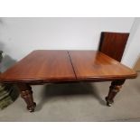 19th Century mahogany extending dining, Raised on four turned supports, set on castors. Together