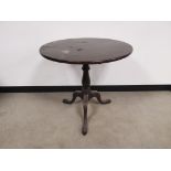 Georgian circular tilt top occasional table, raised on a turned column and tripod sabre supports.