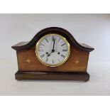 A 20th Century mahogany mantelpiece clock raised on four brass ball feet, with enamel dial and Roman