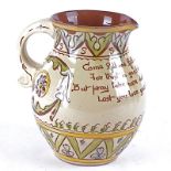 An Aller Vale pottery jug with cream glaze and sgraffito decoration, with the motto "Come fill me