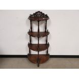 Mahogany four tier wot-not, On turned supports with turned pointed finials. Carved detail back to