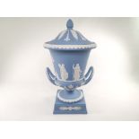 A 20th Century boxed Wedgwood jasper ware twin handled covered urn, with Neo-Classical decoration,