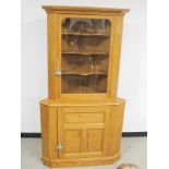An Alan Solly contemporary two section oak corner cupboard, the upper section having a moulded