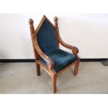 Gothic stained pine arm chair, Having apex back, carved extended supports to the shoulders,