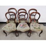 Set of six mahogany balloon back side chairs, Embroidered floral seats, raised on sabre legs to