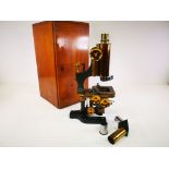 A mahogany cased microscope by W.Watson & Sons Holbourne, on black enamelled stand, height including
