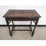 Oak rectangular occasional table, With stain finish, turned supports and carved pattern frieze.