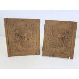A pair of late 19th or early 20th Century Black Forest carved wooden book covers with a design of
