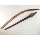 Two ethnographic treen items, a hunting boomerang and a tribal design club, length of club 73cm