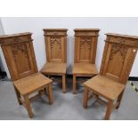 Four oak single Gothic side chairs, with carved arch decoration to the back rests.