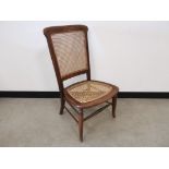 Nursing chair with cane back and seat, With turned front stretcher and turned front supports. 45cm W