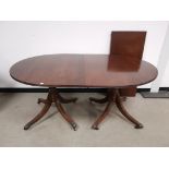 Mahogany tilt top D ended dining table, With additional leaf. Raised on turned column and four