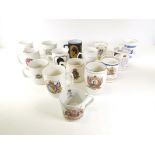A George V coronation mug, together with an assortment of 20th Century commemorative ware mugs and