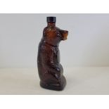 A brown glass bottle in the form of a bear, with impressed numerals 'X729S2UB' to base, height 26cm