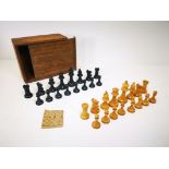 Complete early 20th Century chess set, comprising of 32 turned wooden pieces, together with wooden