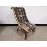 Embroidered and beaded nursing chair, with floral beaded design, on green fabric. General wear