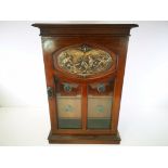 Mahogany reproduction smokers cabinet, with mythical embossed plaque to the twin glazed door,
