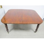 A 19th Century mahogany dining table, drawer leaf action, rounded top with two extra leaves,