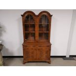 Burr walnut glazed wall cabinet, With glazed doors to the upper section, two internal shelves and