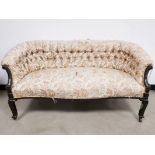 19th Century button backed settee, with woven floral upholstery, raised on four wooden legs having