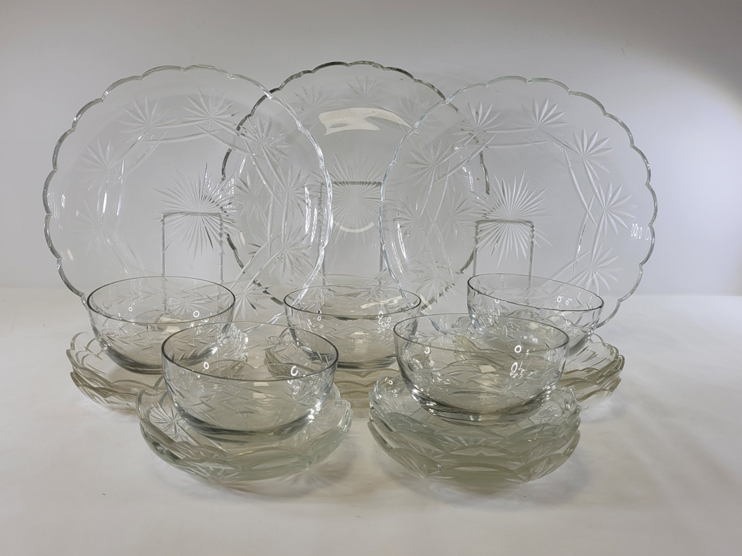 An early 20th Century glass serving set of floriform shape, to include graduated dishes, the largest