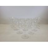 Twenty two drinking glasses with deep flaring bowls, the smaller examples with thin stems, height