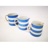 A set of three graduated T.G.Green blue and white striped jugs, largest being 18cm L x 13cm W x 13xm