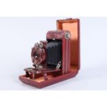 A Kodak Vanity Series III Vest Pocket Camera, red, shutter working, body G-VG, some light wear to