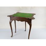 An early 20th Century Queen Anne style carved oak card table, with gate leg mechanism, fold over top