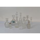 A collection of ten miscellaneous decanters and some associated stoppers